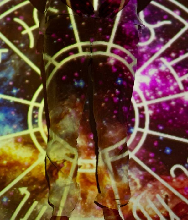 Woman performing a gentle and mindful yoga pose in a bright, clean space.